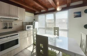 a kitchen with a counter top and a table with chairs at Kabakum Sea Apartment in Varna City +1 photo