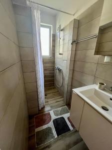 a bathroom with a sink and a shower at Studio Thermi 1 in Varna City