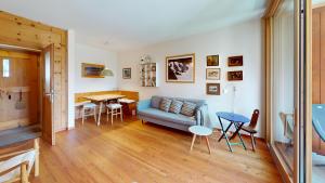a living room with a couch and a table at Alvra 1 in Celerina +15 photos