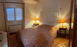 a bedroom with a bed and two lamps on two tables at La traboule in La Tranche-sur-Mer +5 photos