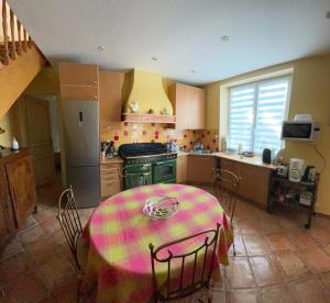 a kitchen with a table with a colorful table cloth on it at La traboule in La Tranche-sur-Mer