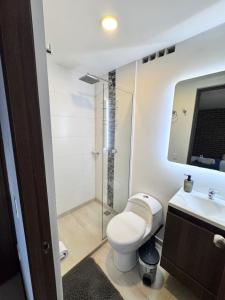 a bathroom with a toilet and a glass shower at 2211 Despierta en poblado Medellín - Vista panorámica in Medellín