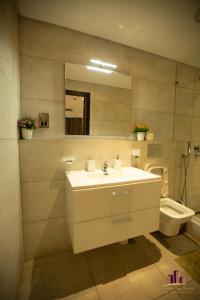 a bathroom with a sink and a toilet at RoyalRest at Signature CPG in Accra