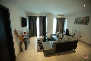 a living room with a couch and a table at RoyalRest at Signature CPG in Accra