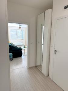 an open door to a living room with a mirror at PonaSpace Apartment in Husovice +3 photos