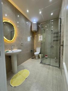 a bathroom with a shower and a sink and a toilet at فيلا فاخرة بشاطئ خاص وإطلالة ساحرة على البحيرة in El Alamein