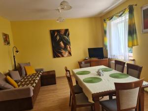 a living room with a table and a couch at Noclegi Stara Fabryka Jedlina-Zdrój in Jedlina-Zdrój