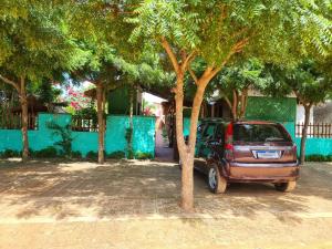 a car parked in front of a house with trees at Pousada Brasil - São Miguel do Gostoso in São Miguel do Gostoso