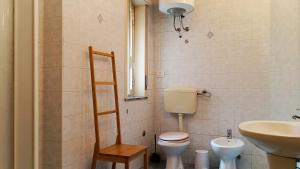 a small bathroom with a toilet and a sink at Medoro Piazza Roma Rooms in Milazzo +75 photos