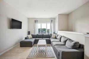 a living room with a couch and a table at Luxurious 4BR home with patio and parking x Fits 8 to 10 in Washington