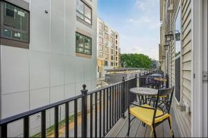 a balcony with a table and chairs on a building at Luxurious 4BR home with patio and parking x Fits 8 to 10 in Washington