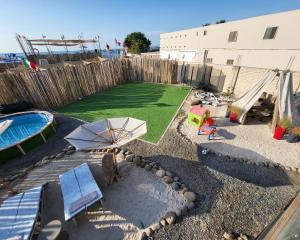 a backyard with a pool and a playground with an umbrella at El Santuario Paracas in Paracas +26 photos