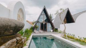 an external view of a house with a swimming pool at Private villa 1 bedrooms Kaba-kaba tabanan in Kapal