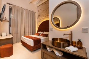 a hotel room with a bed and a mirror at Madonna del Mare City in Chania
