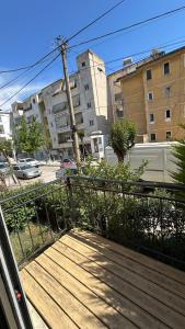 a wooden boardwalk with a fence in a city at Bebi Guest House in Sarandë