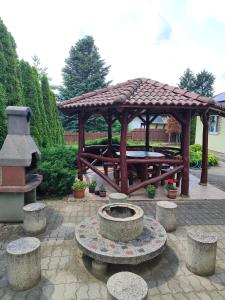 a wooden gazebo with a table and a fountain at Missy House in Igricetanya +7 photos