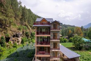 a house on the side of a mountain at Moonlight villa in Kulu