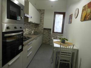 a kitchen with a stove and a table in it at Family Home Salerno in Salerno