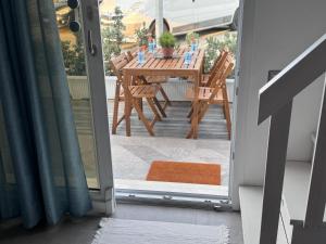 a door leading to a patio with a table and chairs at Le Potager in Quartu SantʼElena