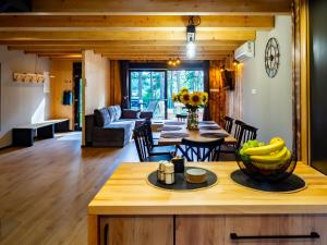 a kitchen and living room with a table and chairs at Lakehouse Lubiatów in Lubiatów