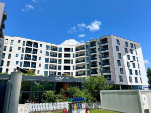a large white building in front of a building at AVIATORII Modern Escape Apartment in Constanţa