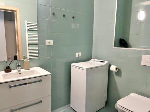 a bathroom with a sink and a toilet and a mirror at AVIATORII Modern Escape Apartment in Constanţa +30 photos