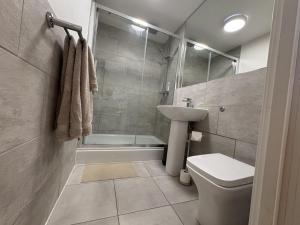 a bathroom with a toilet and a sink and a shower at 1 The orchard - Beautiful Ground floor garden flat in Frampton Cotterell +11 photos