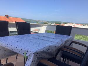 a blue table with chairs on a balcony at Apartment Vitezic in Punat