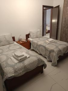 two beds sitting next to each other in a room at Villa Miron in Kamilari +29 photos