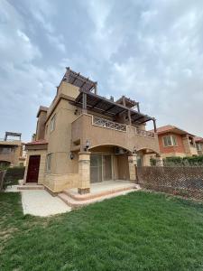 a large house with a balcony on top of it at Coronado Dabaa Beach in Zāwiyat ‘Abd al Mun‘im