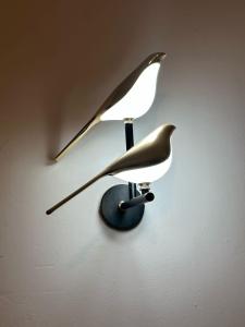 a bird clock hanging on a wall at The Bird House in Ukunda Airport