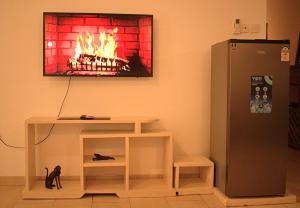 a living room with a fire on the wall at The Bird House in Ukunda Airport