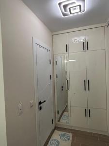 a bathroom with white cabinets and a walk in shower at Sinemorets Blue apartments in Sinemorets +33 photos