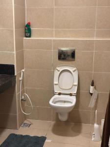 a small bathroom with a toilet and a shower at The Bird House in Ukunda Airport