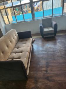 ein Wohnzimmer mit einer Couch und einem Sessel in der Unterkunft Departamento Esmeralda in Chota