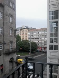 a view of a city street from a balcony at Pensión Hedrass in Santiago de Compostela