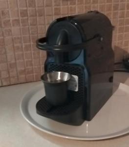 a coffee maker with a cup on a plate at Mani Fort Charabos in Ayía Kiriakí