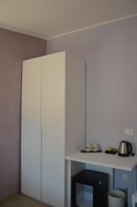 a white cabinet in a room with a table at Salsedine affittacamere in Grottammare