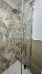 a shower in a bathroom with a wall at Salsedine affittacamere in Grottammare +40 photos