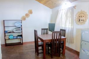 a dining room with a wooden table and chairs at chez Leo in Tuléar