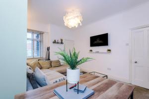 a living room with a couch and a table at Four BR House By Eason Stays Short Lets & Serviced Accommodation Worsley With Free Parking in Worsley