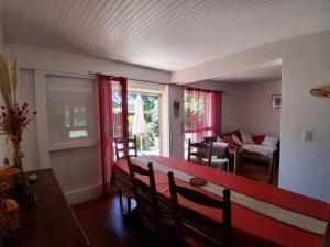 a dining room with a red table and chairs at T3 à Vieux-Boucau-Les-Bains - quartier calme entre commodités et plages - FR-1-239-1134 in Vieux-Boucau-les-Bains +8 photos