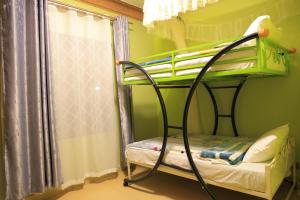 Postel nebo postele na pokoji v ubytování AG Home - Kampala