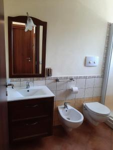 a bathroom with a sink and a toilet and a mirror at La Costa Del Sole in San Fele +24 photos