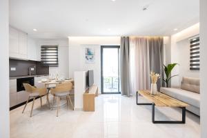 a kitchen and living room with a couch and a table at Unicos City Suites in Kos