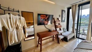 a bedroom with a dressing room with a bed and a desk at Beachfront Studio at Zantamar in Cruz de Huanacaxtle