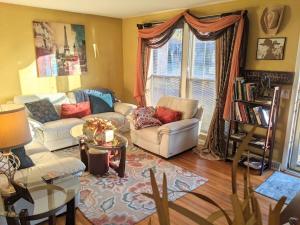 a living room with two couches and a table at The Place Between The Lakes 4 Bedrooms 4 Beds in Old Hickory
