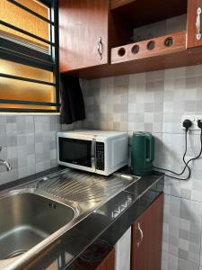 a microwave sitting on top of a kitchen counter at Rest & Nest in Kampala