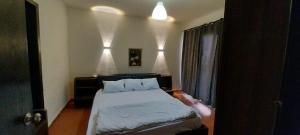 a bedroom with a bed and a door with a person reaching into it at Porte Hotel in Az Za‘farānah +21 photos