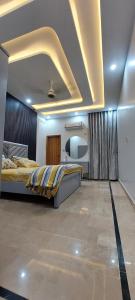 a bedroom with a large bed in a room at Entire Ground Floor Elegance 3BR Gulistan e Joher Blk 14 Near Darul Sehat Hospital in Karachi